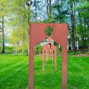 Metal art sculptures of silhouettes in a field